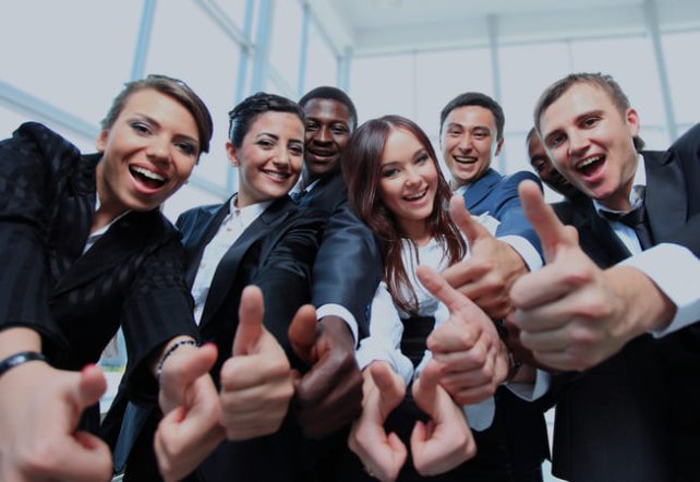colleagues in a company holding thumbs up